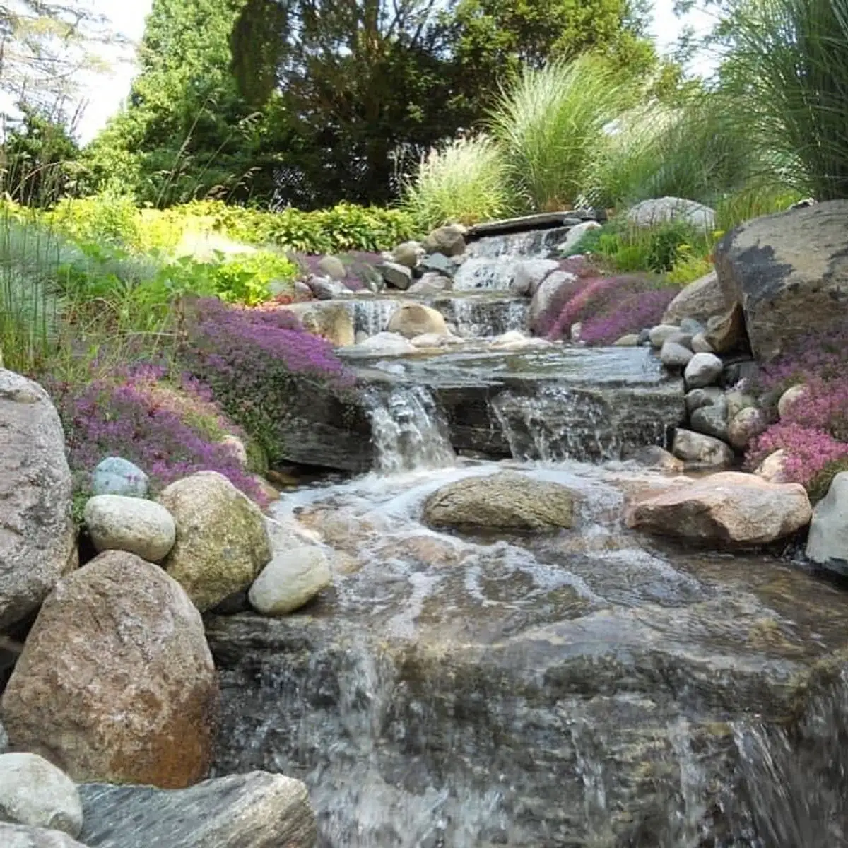 Boulder retaining wall built by Earth Art Landscaping