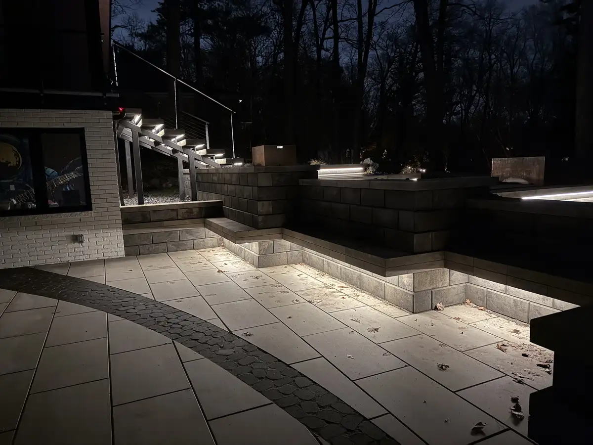 Night landscape lighting on paver walkway by Earth Art